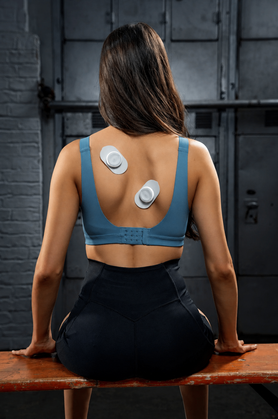 Woman applying the Calvonic TENS Pod to lower back